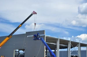 close up of cranes constructing warehouse structure