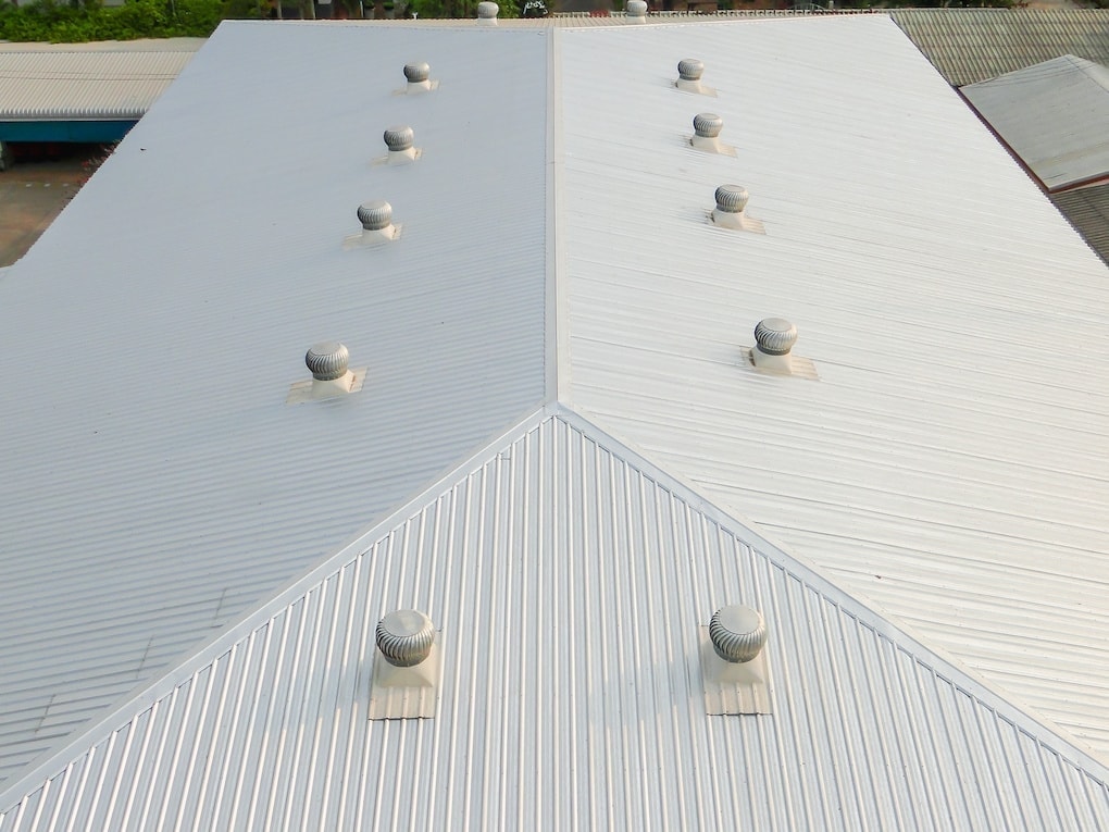 white commercial roof with warehouse ventilation on top