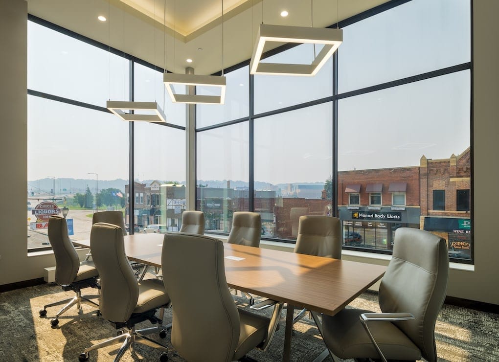 large corporate table inside glass office; office remodeling contractors