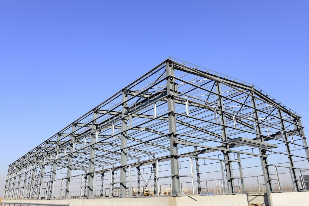 bare metal frame of a new warehouse; pre-engineered metal buildings average cost