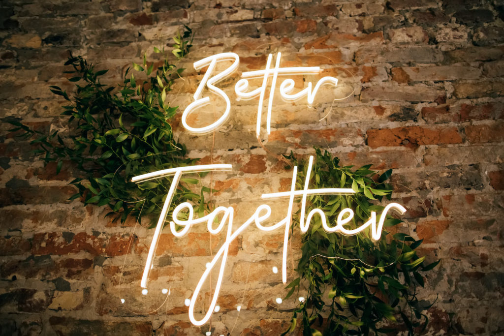 neon sign on wall, a popular restaurant design trend. The sign reads "better together"
