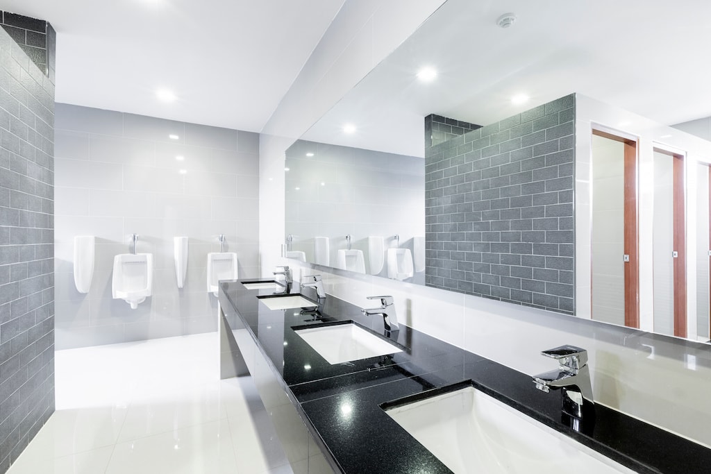 public Interior of spotless modern bathroom; commercial bathroom remodeling