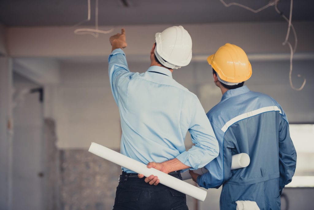 two men on Jobsite going over commercial bathroom remodeling costs