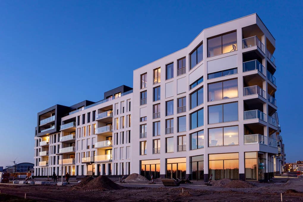 newly constructed apartment building during dusk; modern apartment building designs