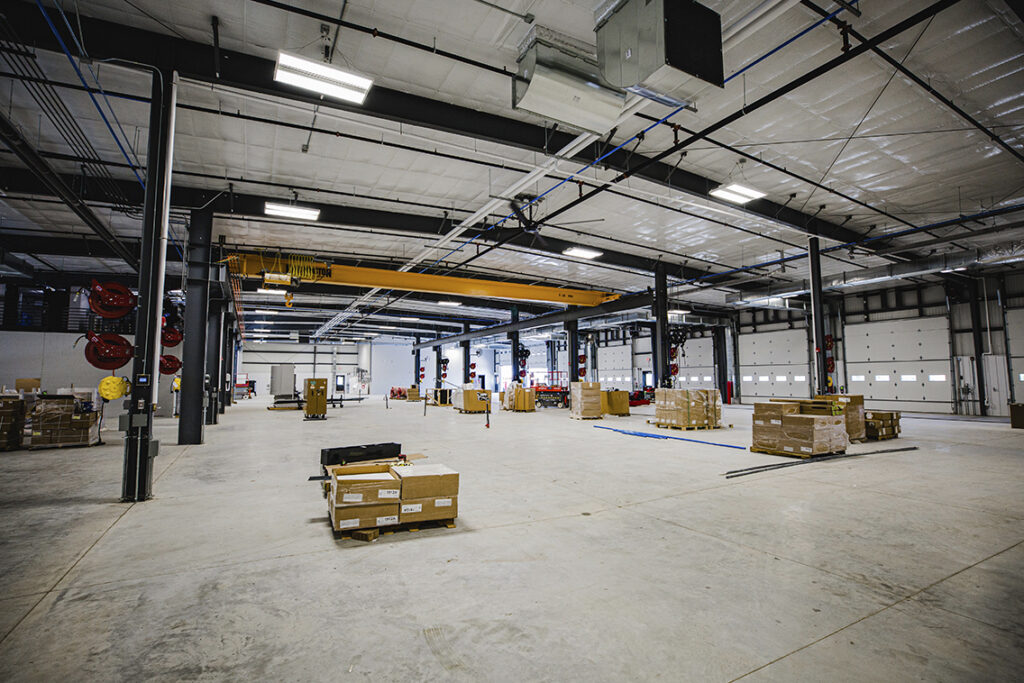 Warehouse interior with trucks and storage areas.