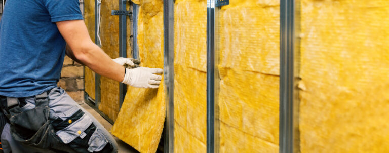 Worker installing insulation