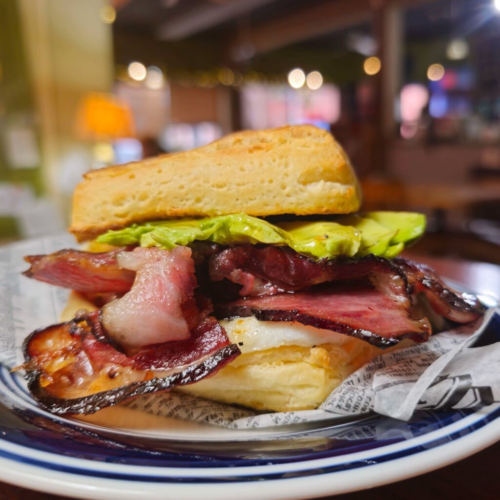 Bacon avocado, honey, and egg on a croissant